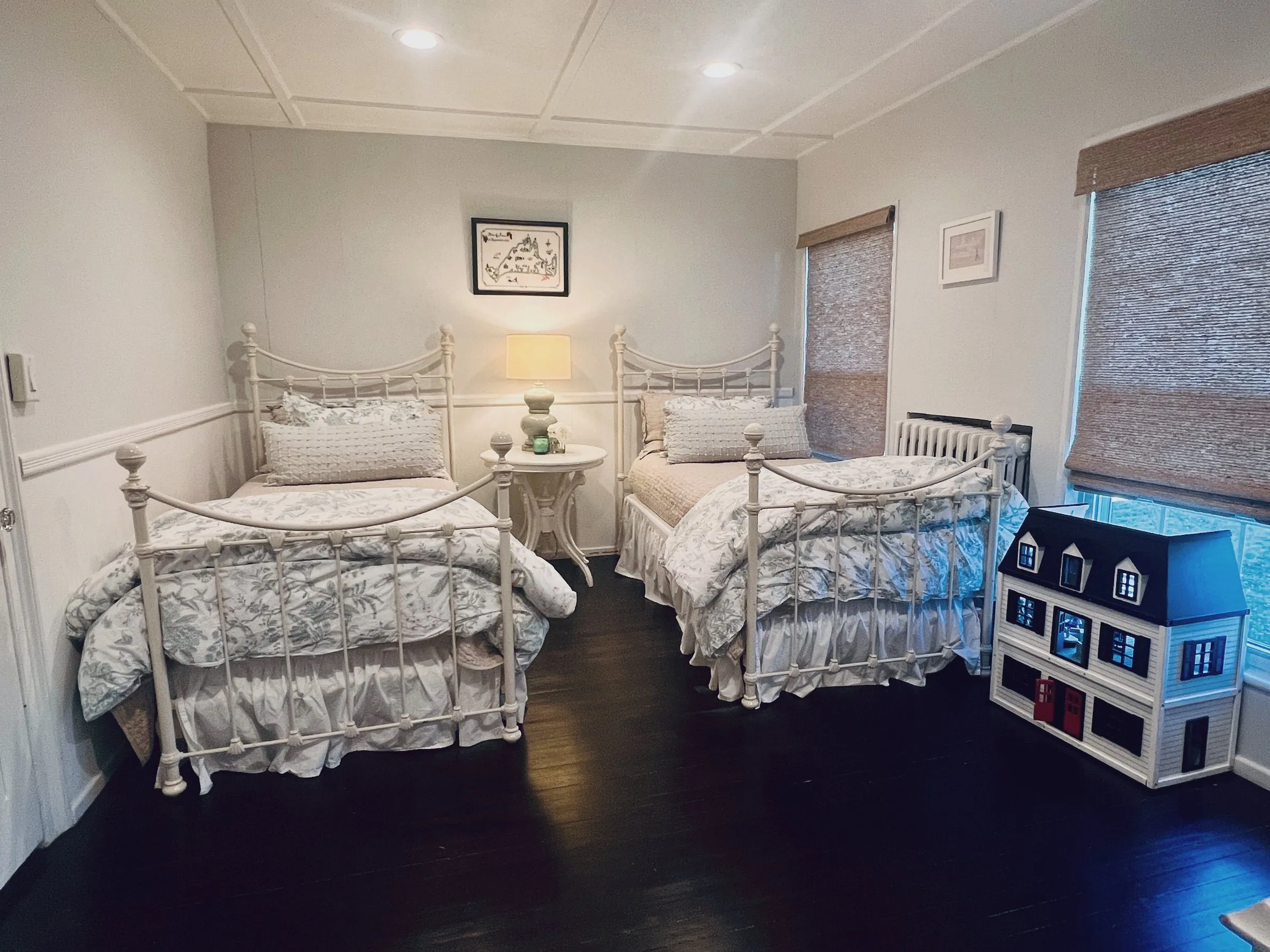 The twin room — two iron twin beds and a dollhouse