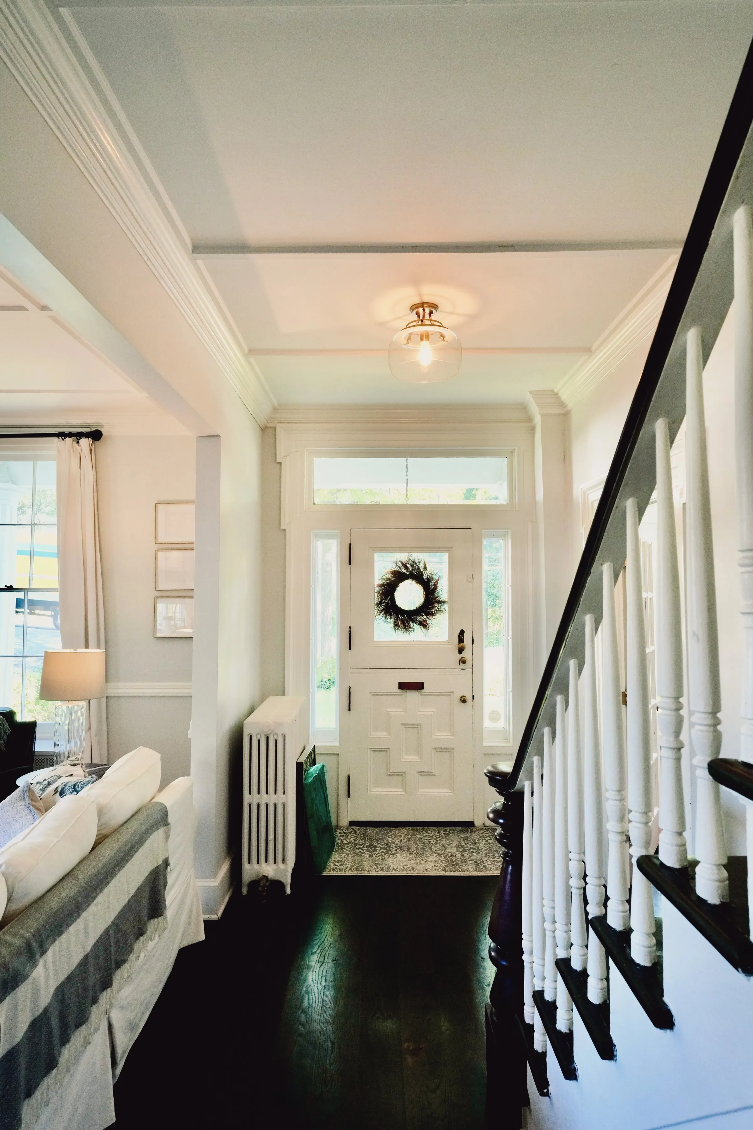 The entry hall — original staircase and front door