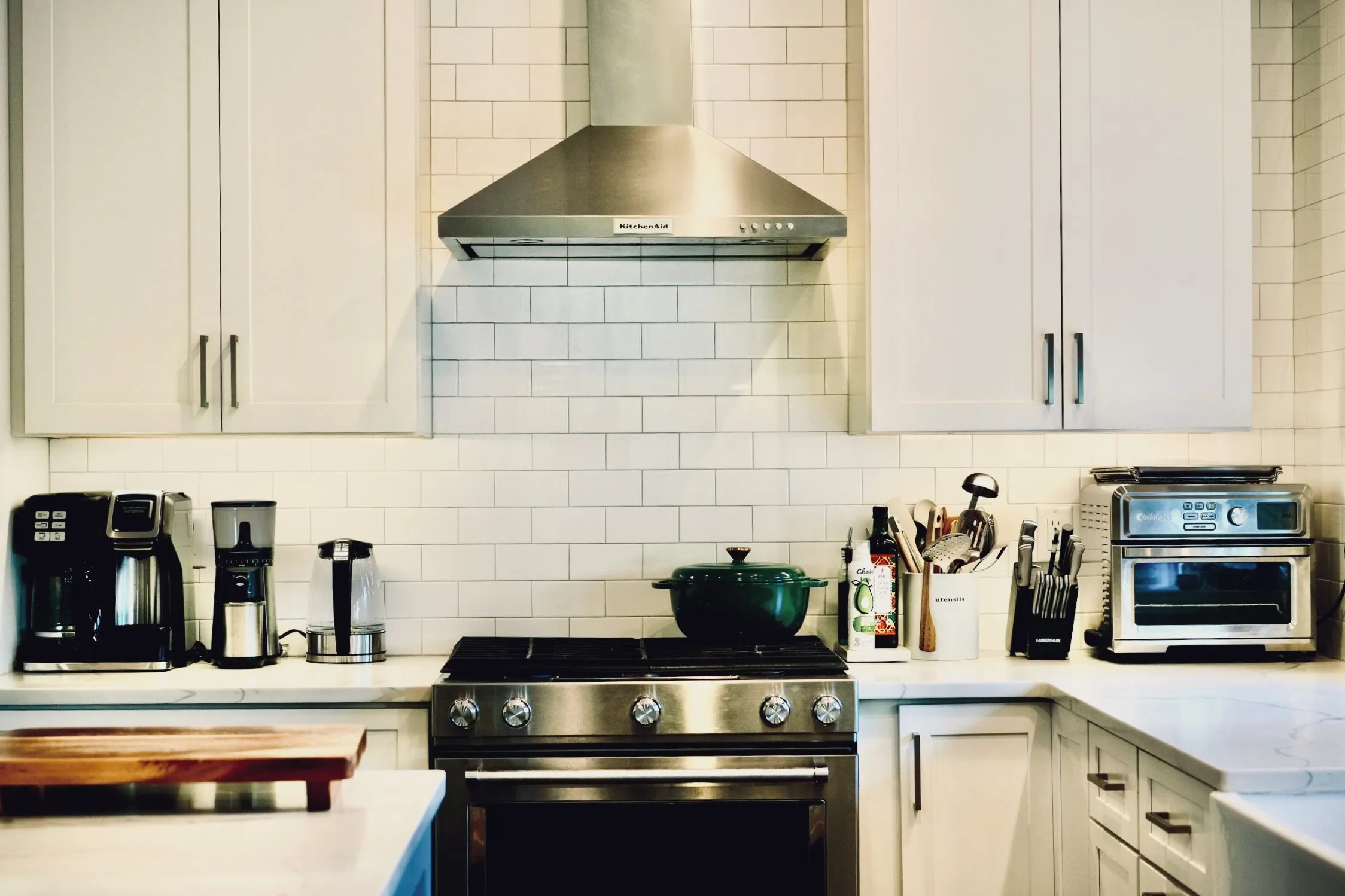 The renovated kitchen — gas range, white subway tile