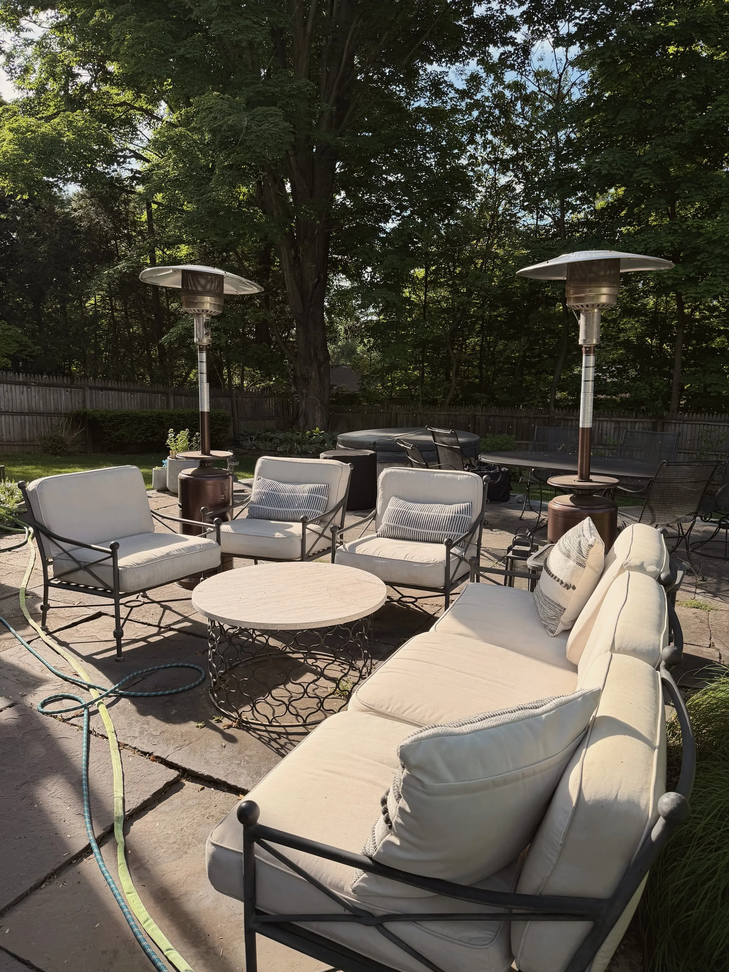 The patio lounge under heaters, rhododendron behind
