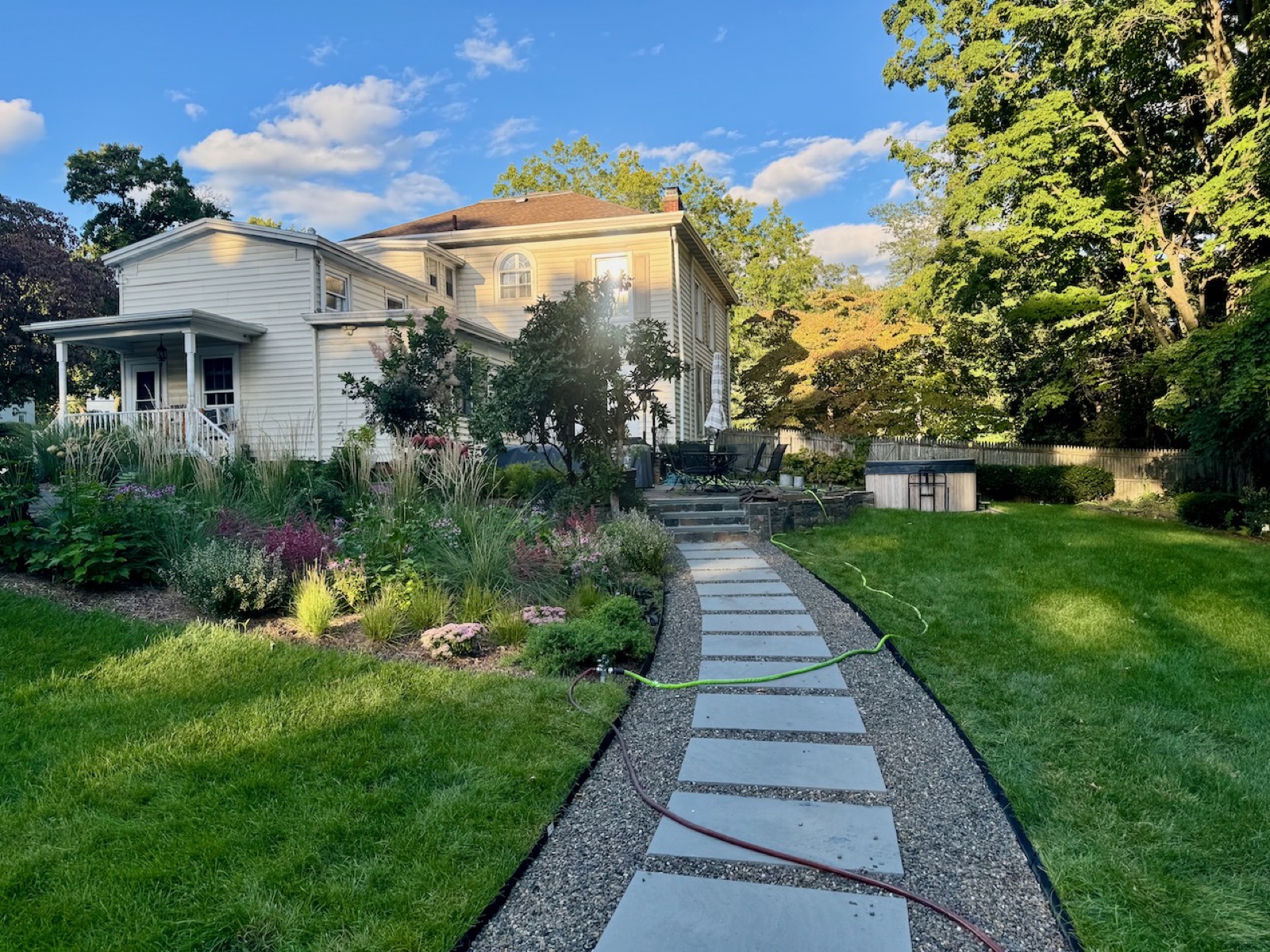 The middle yard, the cedar tub, and a great many plants